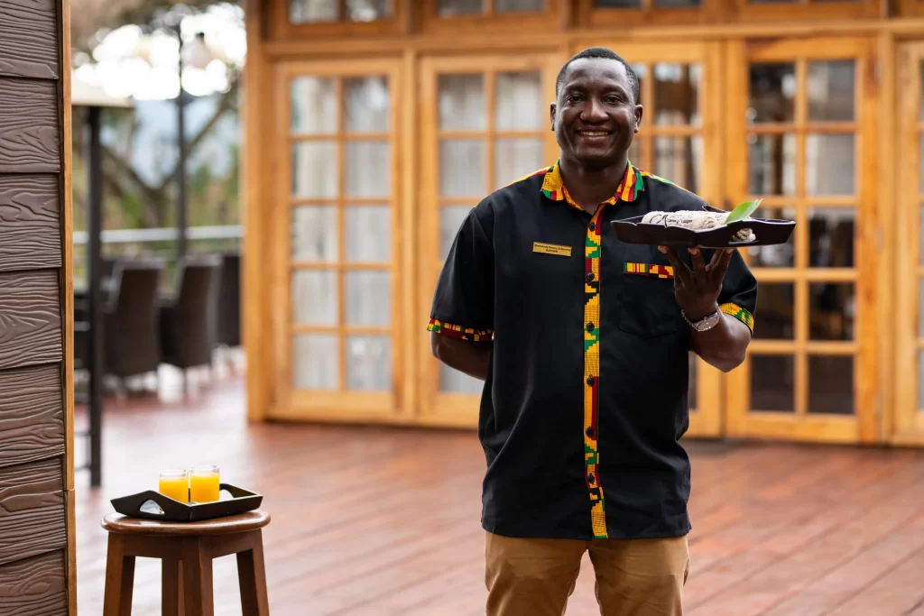 Lion's paw staff all smiles welcoming guests with warm towels and juice at the entrance