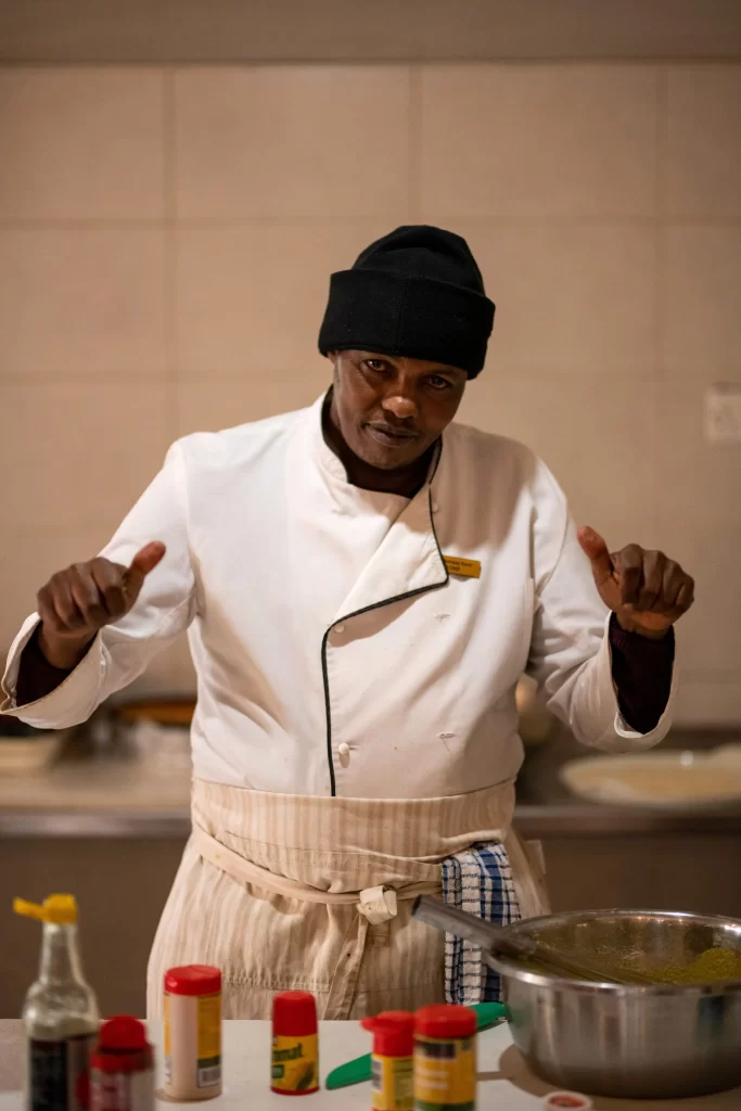 Lion's paw chef thumbs up while preparing meals in the kitchen