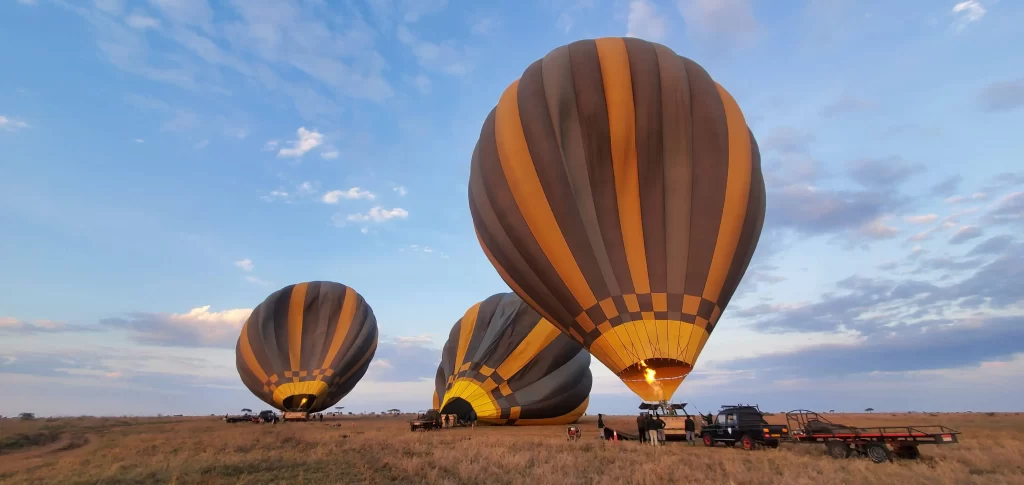 Serengeti woodlands camp guests getting on board for their Balloon safari